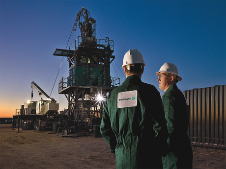 Two Baker Hughes employees at a coiled-tubing rig site